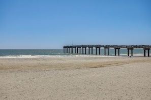 A beach with a wooden pier extending into the ocean. - Walk to St Augustine Beach! Condo w/ Pool Access (St Augustine Beach)