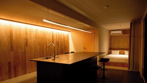 A modern kitchen with a wooden countertop, a sink, and bar stools. - No.12 Kashima Fan Zone (Kashima)