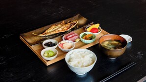 A wooden tray with various dishes including fish, vegetables, and rice, accompanied by chopsticks and a bowl of soup. - No.12 Kashima Fan Zone (Kashima)