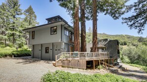 A two-story house with a deck, surrounded by tall trees and a gravel driveway. - 11 Mi to Downtown Napa: Wine Country Cottage (Napa)