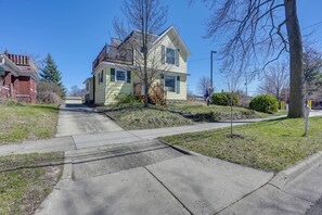 Stroll up to this charming two-story home, featuring a spacious front porch and a staircase leading to the second floor.