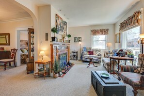 Cozy living room with a fireplace, comfortable seating, and classic furniture.