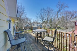Enjoy a meal or relax with family on the deck, surrounded by trees and a clear sky.