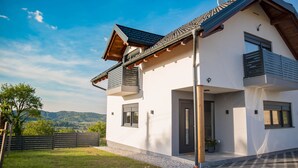 A modern two-story house with a balcony, a garage, and a view of the countryside. - Villa Old Hills by Villas Guide (Ljubešcica)