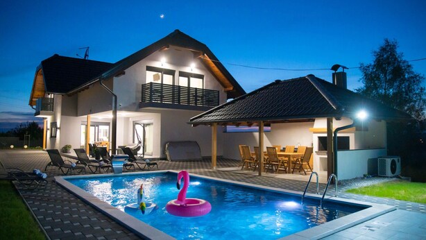 A two-story house with a swimming pool, outdoor seating, and a covered patio area. - Villa Old Hills by Villas Guide (Ljubešcica)