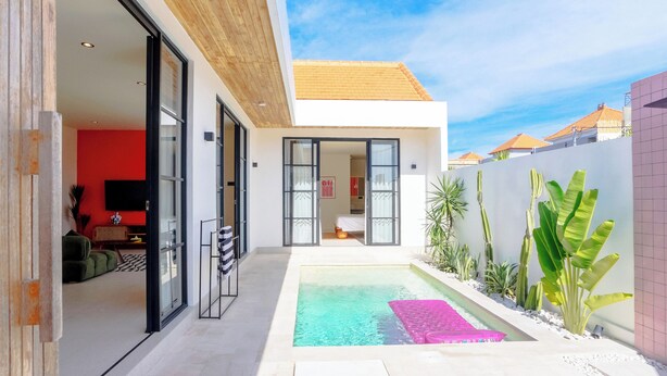 A modern house with a swimming pool, a red interior, and a wooden ceiling. - Stylish Private Pool Villa in Pererenan (Munggu)