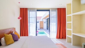A hotel room with a large bed, a wooden headboard, and a view of a pool through an open door. - Stylish Private Pool Villa in Pererenan (Munggu)