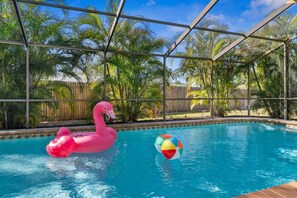 A swimming pool with a pink flamingo float and a beach ball. - Florida Fun! Beach Theme, Heated Pool, Near Siesta (Sarasota)