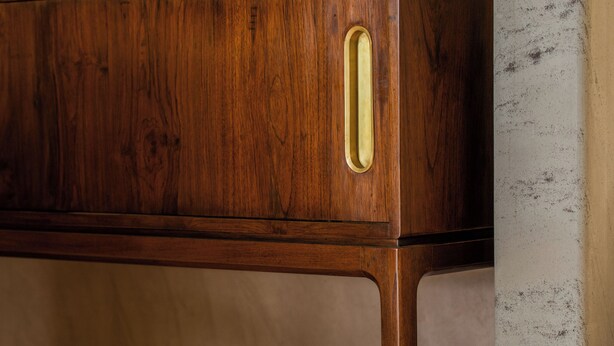 A wooden cabinet with a bowl of fruit on top. - Amaya Kasauli (Krishangarh)