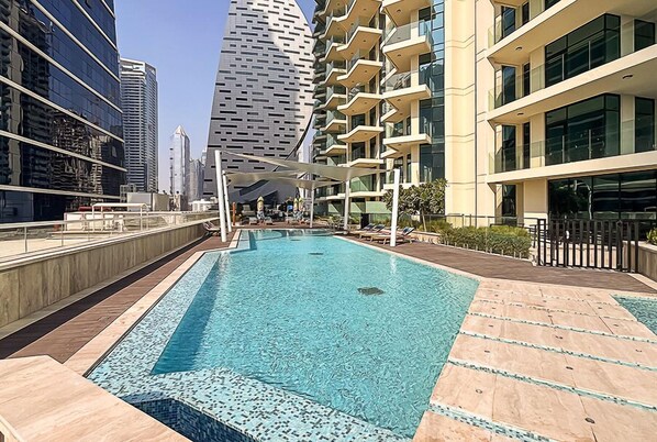 A rooftop pool with a clear view of surrounding high-rise buildings.
