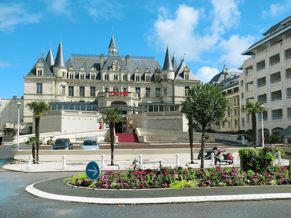 A grand hotel with a classic architectural style, featuring multiple towers and a prominent entrance.