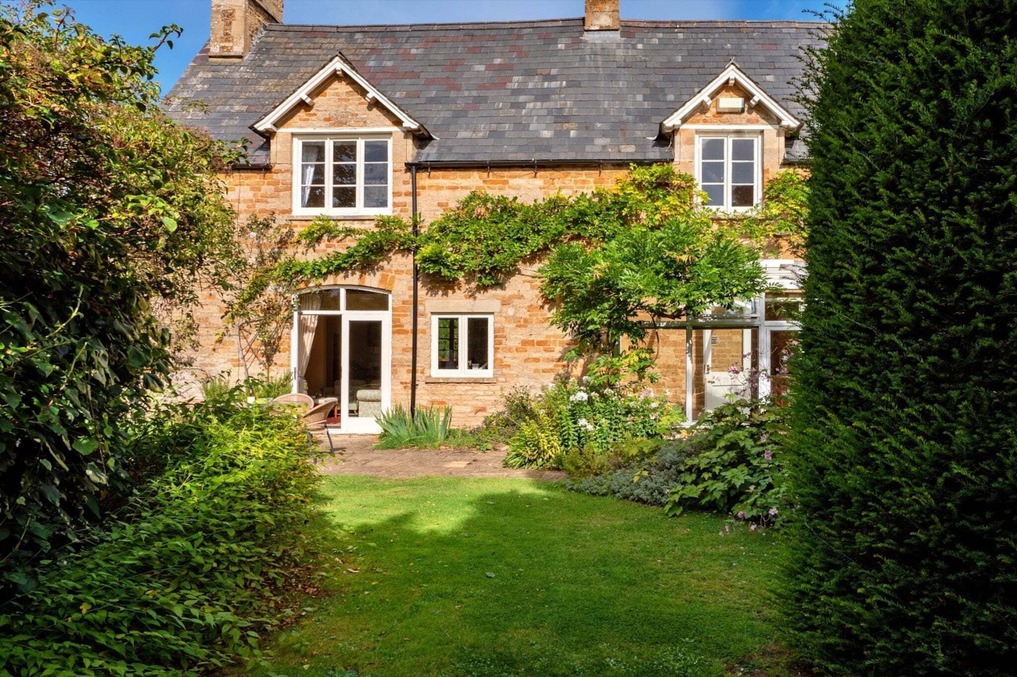 A stone house with a garden.
