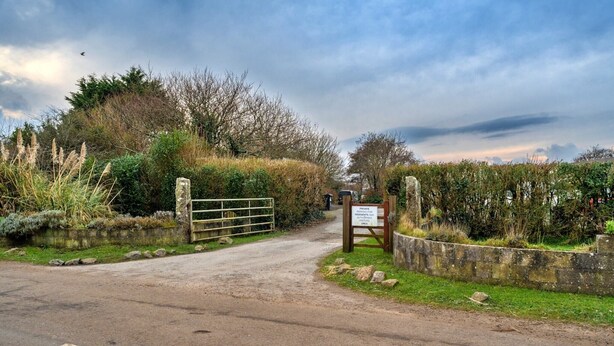 A private road leading to a gated entrance with a sign indicating restricted access. - Holiday Home near Nanjizal Cove & Coastal Path (Sennen)