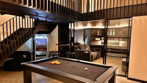 A pool table in a modern interior with a staircase and a seating area. - Holiday Home in Kent with Hot Tub & Games Room (Appledore)