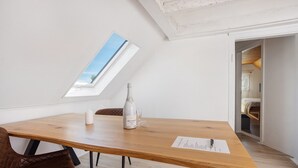 A dining area with a wooden table, a bottle, and a menu. - Holiday Apartment 'Traumhaft' with Shared Garden and Wi-Fi (Wasserburg)