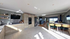 Enjoy cooking in this well-lit kitchen with a central island and ample counter space, featuring an oven and microwave.