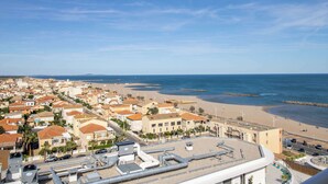 A coastal town with buildings, a beach, and a clear sky. - ValrasLoc Panarea with Large Terrace (Valras-Plage)