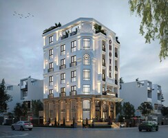Un hotel de varios pisos con un diseño arquitectónico clásico, que cuenta con balcones y ventanas amplias.
