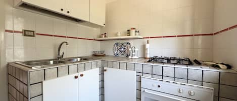 Fridge, oven, coffee/tea maker, cookware/dishes/utensils