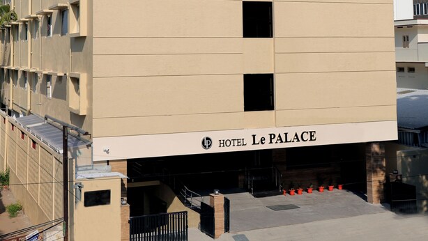 A hotel building with a flat facade, multiple windows, and a sign reading "HOTEL Le PALACE". - Hotel Le Palace  (Coimbatore)