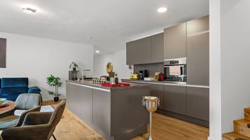 Deluxe Condo, Balcony | Private kitchen | Full-sized fridge, oven, stovetop, dishwasher