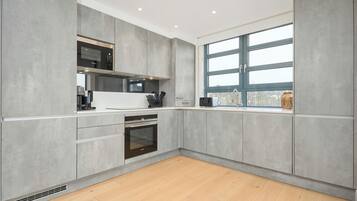 Deluxe Apartment, Balcony | Private kitchen | Full-size fridge, microwave, oven, stovetop