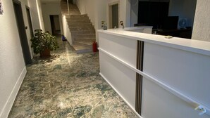 A hallway with a marble floor, a staircase, and a reception desk. - Deniz Butik Hotel (Tekirdag)