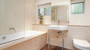 Ein Badezimmer mit einer Badewanne, einem Waschbecken und einer Toilette.