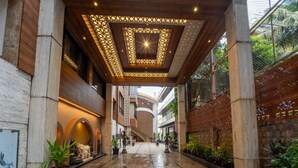 A spacious corridor with a high ceiling, featuring a geometric light fixture and a central skylight. - GRANDEUR SANCHI RESORT (Calangute)