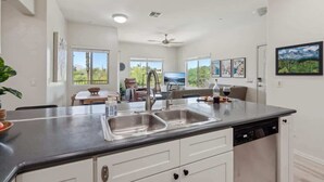A modern kitchen with a large island, double sink, and dishwasher. - Panorama View - Mountain Views - Community Pool (Fountain Hills)
