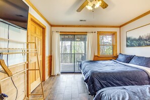 A bedroom with a bed, a wooden ladder, a ceiling fan, and a window with curtains. - 10 Mi to Waynesville: Cabin w/ Hot Tub & Mtn Views (Balsam)