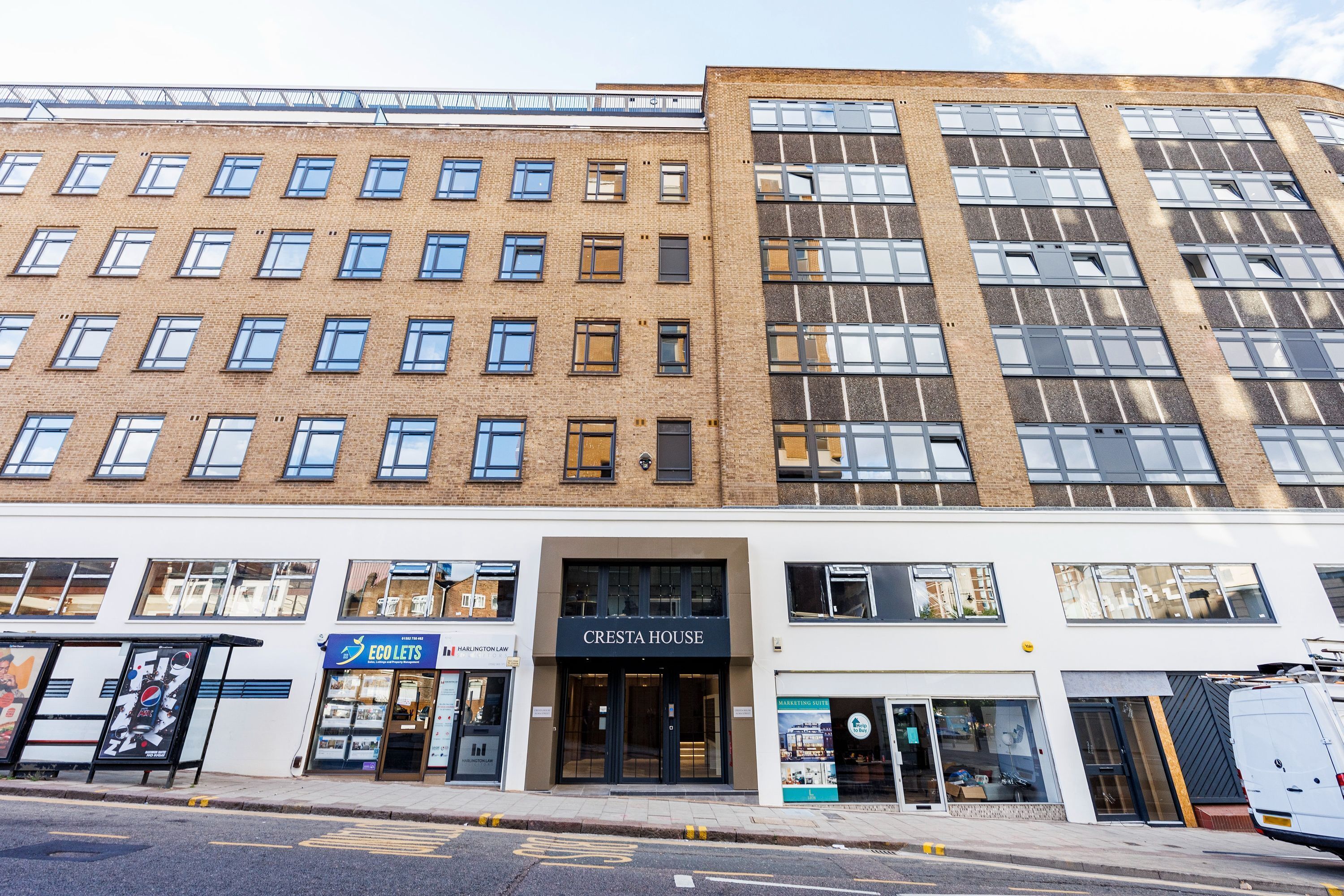 A multi-story building with a modern facade, featuring a prominent 'CRESTA HOUSE' sign.
