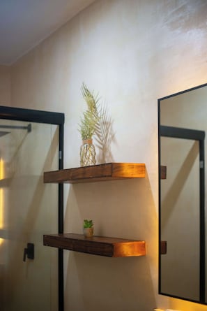 A wall-mounted wooden shelf with a small potted plant and a decorative item. - Bright Tulum 2BR - Rooftop Pool near Aldea Zama (Tulum)