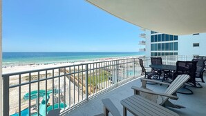 A balcony with a view of the beach and a water slide. - New Complex!  Beachfront 4BR, 5TH FLOOR!, Lazy River and Water Slide! (Gulf Shores)