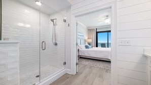 A modern bathroom with a glass-enclosed shower, a walk-in shower, and a visible bathtub. - New Complex!  Beachfront 3BR! 4TH FLOOR!!  LAZY RIVER and WATER SLIDE!! (Gulf Shores)