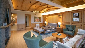 A spacious living room with a wooden ceiling, a large bed, a sofa, and a coffee table. - RajBagh Shimla (Shimla)