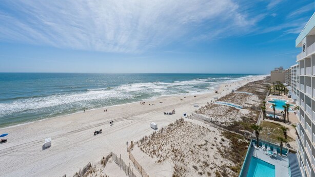 A beach view with a hotel and a swimming pool. - Crystal Shores West 208 (Gulf Shores)