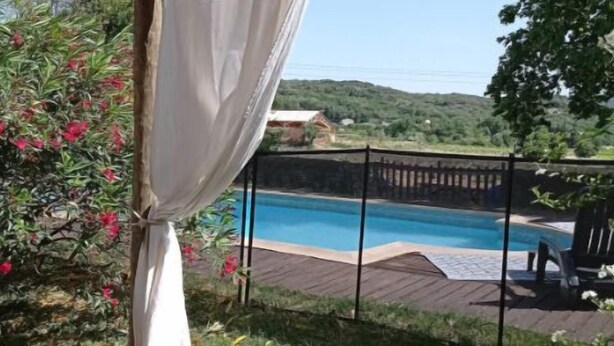 A covered outdoor area with a pool, surrounded by greenery and hills in the background. - Mas la Mayanne in the heart of the vineyards. (Vénéjan)