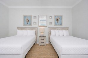 A double room with two beds, a nightstand with a lamp, and wall art. - Phoenix Gulf Shores Ii 1102 3 Bedroom Condo (Gulf Shores)