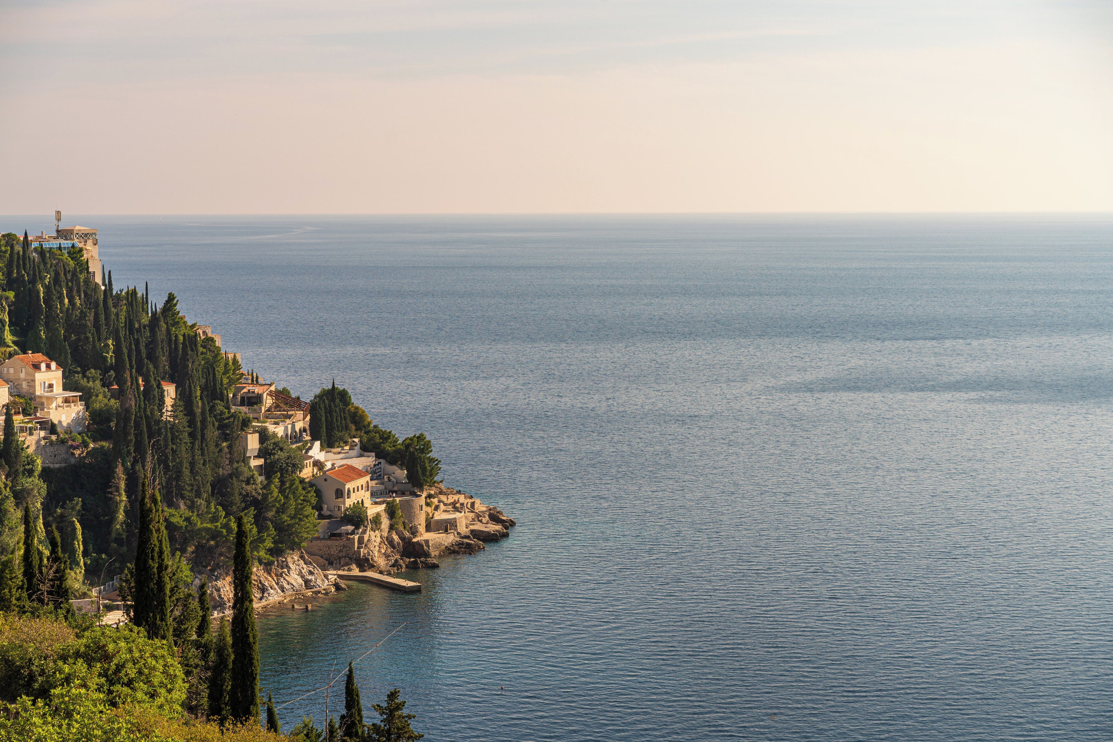 A coastal town with buildings on a hillside overlooking the sea.