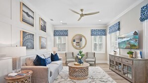 A spacious living room with a sofa, chairs, a coffee table, and a TV. - 2 Steps to Ice Plant Downtown St Aug Beach Club (St. Augustine)