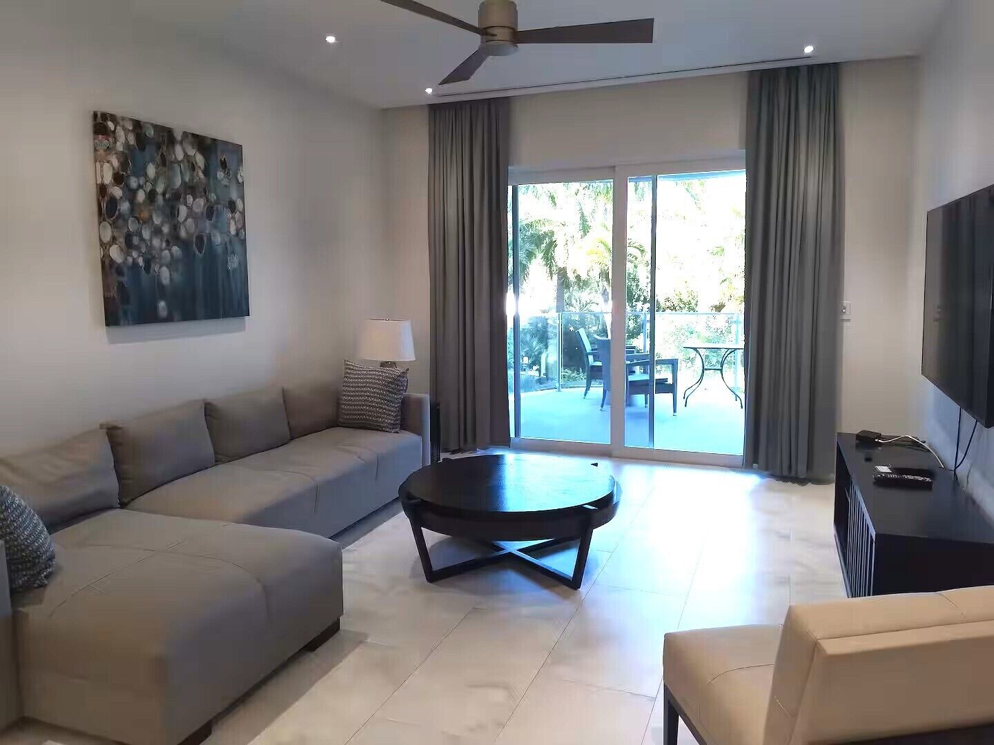 A modern living room with a sofa, a coffee table, and a TV.