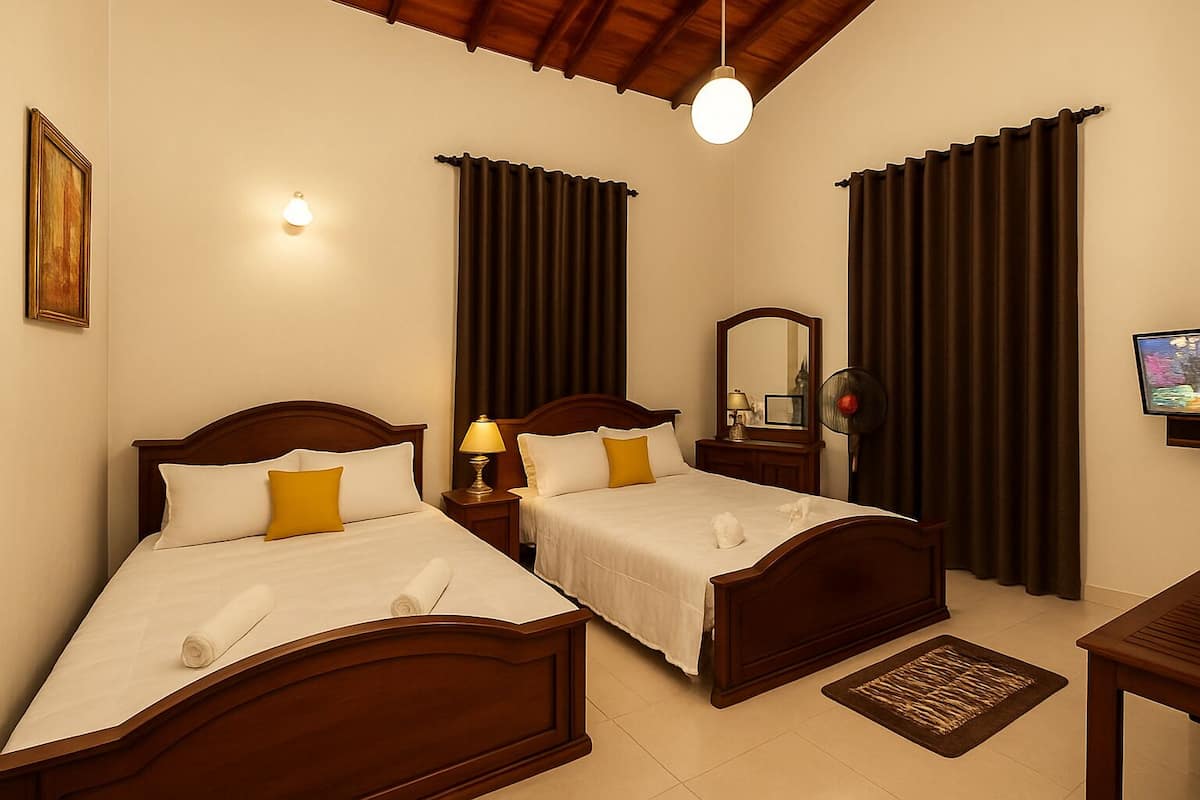 A hotel room with two beds, a wooden ceiling, a wall-mounted TV, and a small table.