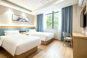 A hotel room with two beds, a desk, a chair, a TV, and a window with curtains. - Fule Selected Hotel (Shanghai)
