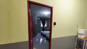 A hotel room with a bed, a small table, a sink, and a window with curtains. - Hotel O Selesa Inn (Kuala Berang)