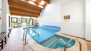 An indoor swimming pool with wooden beams, benches, and a tiled floor. - Lodge in Thirsk With Spa & Countryside Views (Thirsk)