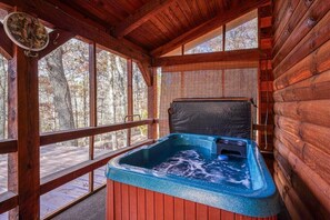 A wooden cabin with a hot tub on a deck. - Tranquility Ridge | Hocking Hills, 5 Acres, Pets (Logan)