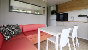 A modern kitchen with white cabinets, a microwave, and a sink. - Chalet by Hegermeer With Lake Access (Heeg)