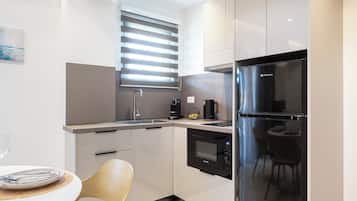 Family Apartment, Balcony | Private kitchen | Full-size fridge, microwave, espresso maker, electric kettle