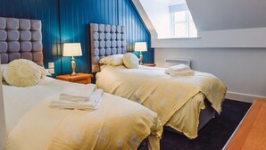A hotel room with two beds, a skylight, and a modern design. - The Raven (Claines)